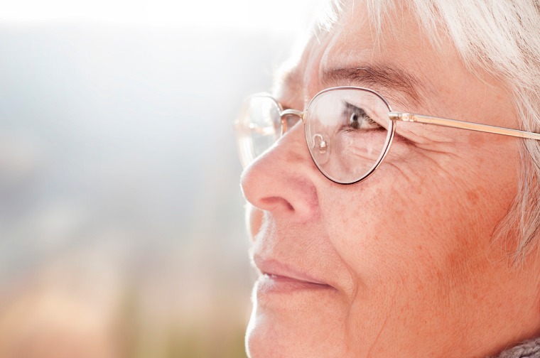 Mature woman looking outside