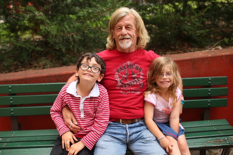 Terry sitting on a bench with his kids. He used to be a rugby star but became homeless